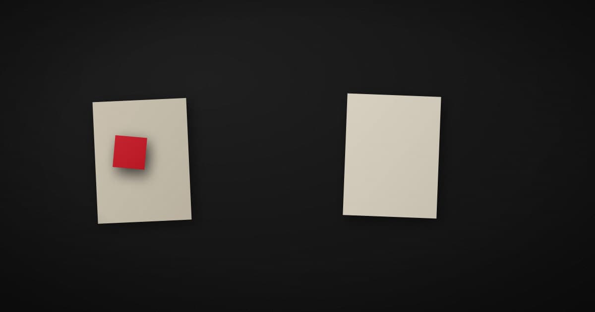 Two pale paper sheets on a dark surface, one patched with a small crimson square and the other blank and whole